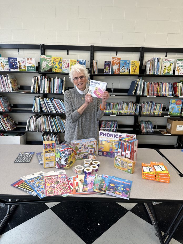 A woman holds up a book
