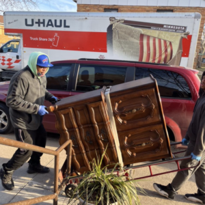 A man moves a dresser