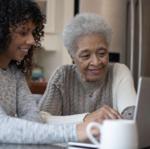 A woman shows her mother about social security.