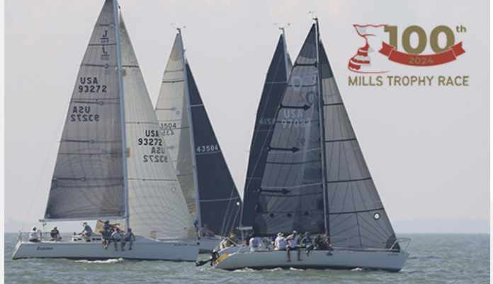 Boats sailing on water with 100th Mills Trophy logo.
